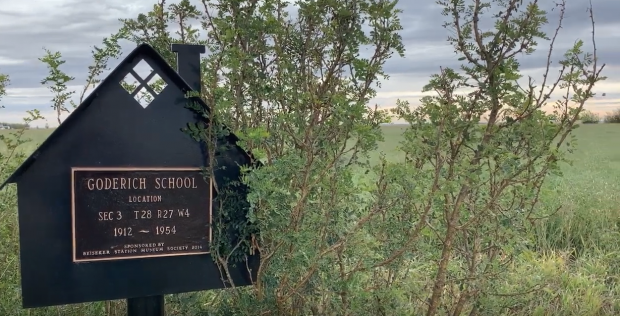 Sign in shrubs marking site of Goderich School, 1912-1954.