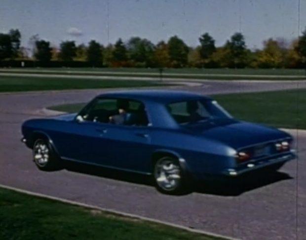 A 1960s sports car on a winding test track.