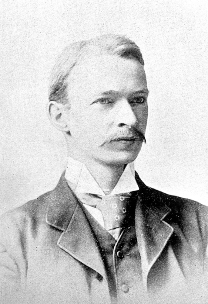 Bust portrait of a well-dressed man in a 19th-century business suit, with light hair and a prominent moustache.