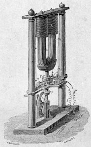 Schéma d’une machine électrique complexe, un aimant en fer à cheval monté sur des engrenages sous deux bobines de fil.