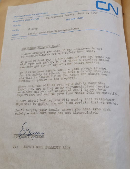 Colour photograph of a memo that has been typed on a typewriter. There is a header with the CN logo at the top righthand corner. There are several subheadings which are filled with typed responses. The memo consists of six paragraphs and is signed at the bottom.