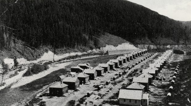 Two long rows of miners cottages beside a river.