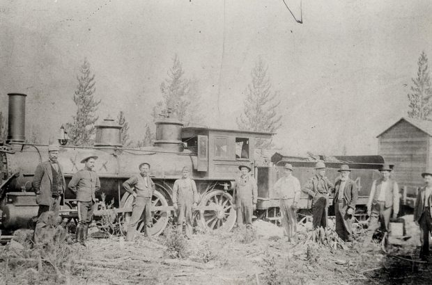 Photograph of a locomotive with a coal car behind it.