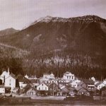 Fernie, BC in 1899 with Mount Fernie in the background and Canadian Pacific Railway locomotive in front.