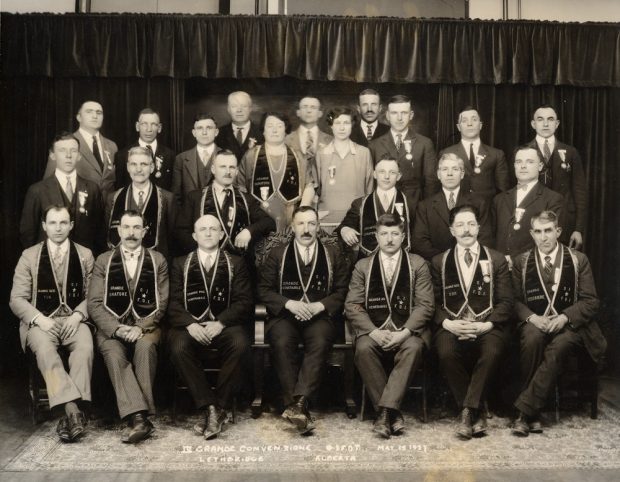 Conference delegates; front row is sitting, three rows behind are standing