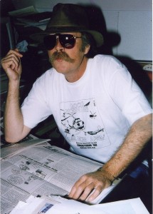 Man in sunglasses and a hat wears t-shirt commemorating fire.