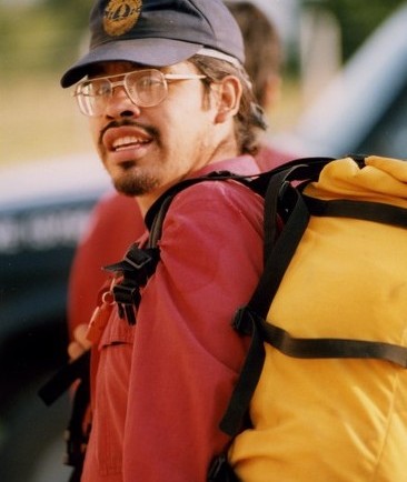 First Nations firefighter with a yellow backpack and wearing a blue ball cap.