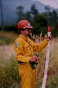 Man in yellow coveralls and red hard hat demonstrates a nozzle change.