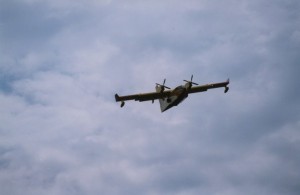 Plane flying in sky. Clouds in background.