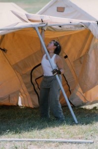 Woman sets up tent.