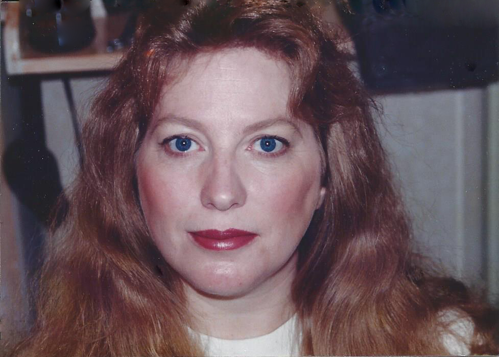 Portrait of a serious red haired woman with blue eyes.