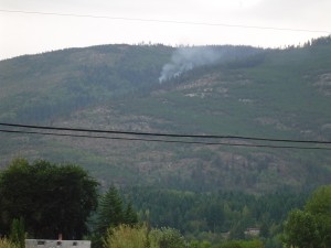 Smoke in forested hills.