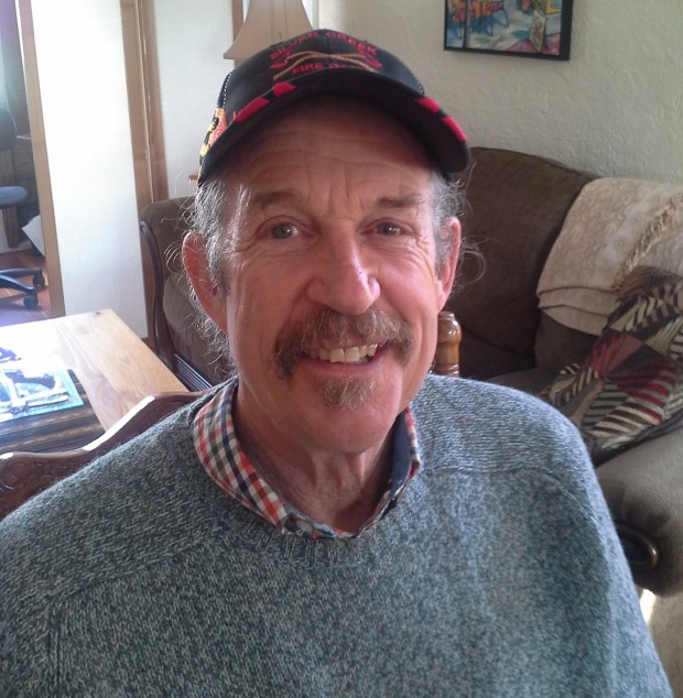 Portrait of a man wearing a baseball cap smiling.