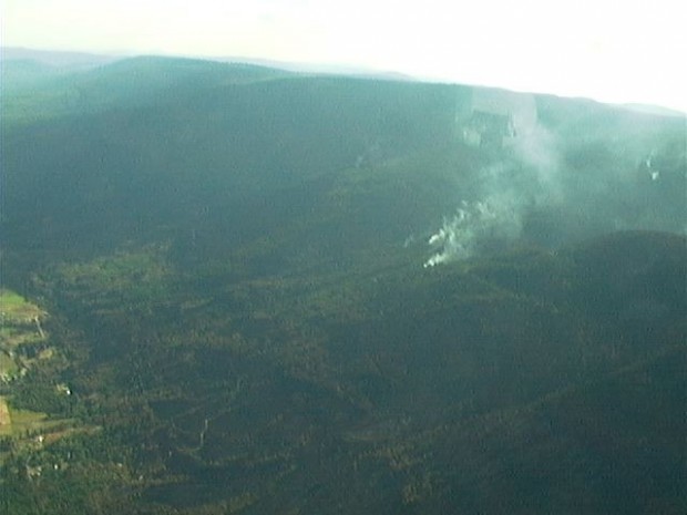 Aerial view of a fire burning on a hill.