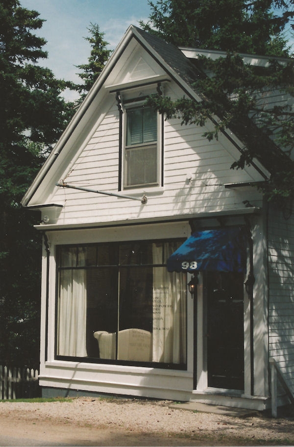 A small white building with large store windows and a door way on the right. This small building was the office of Chester Electric on Duke Street in Chester. It has since been torn down and replaced with a modern residence