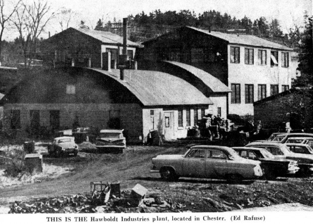 A black and white photo of the company showing the office on North Street with the two-storey machine shop at the back and the domed roof welding and foundry buildings to the left of the machine shop. The worker’s parking lot is shown in the foreground next to the stream.