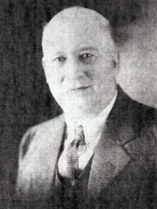 A black and white photo of Forman Hawboldt showing a man with little hair, wide spaced eyes, with a pleasant look, dressed in suit and tie.