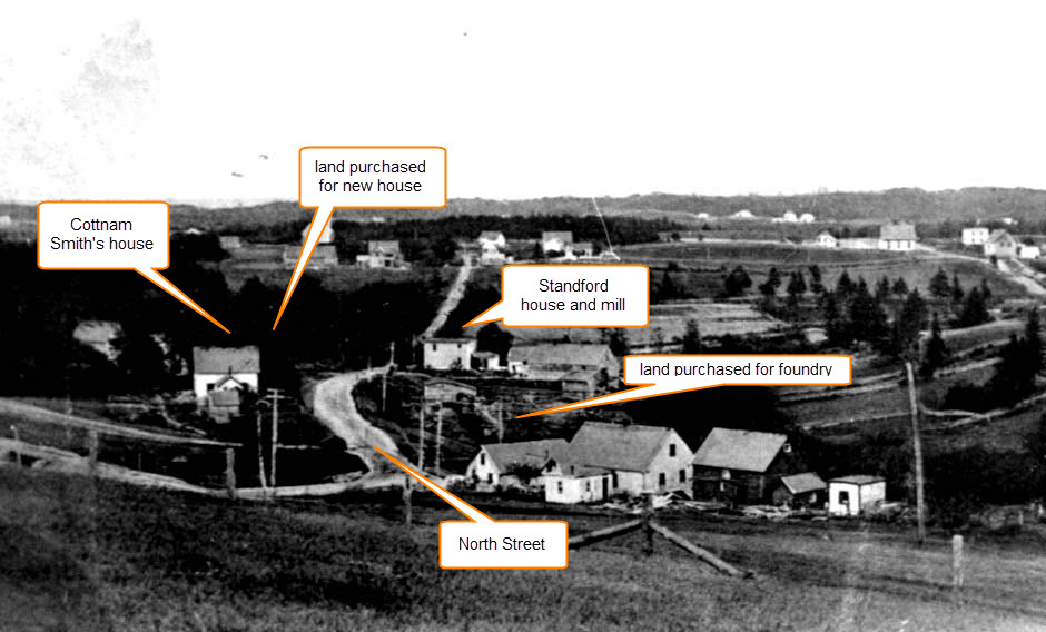 A black and white photo showing the west end of North Street, Chester, with the locations of the foundry land and residence marked. The road runs in the middle of the photo with Cottnman Smith’s house on the left and the Hawboldt house lot further to the east beyond his land. On the right side of the road opposite Smith’s house and running east to the Stanford house is the foundry land and the stream from Stanford Lake.