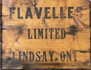 Wood crate with Flavelles Limited Lindsay, ONT printed in bold black printing.