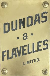 Brass sign with Dundas & Flavelles Limited in black print.