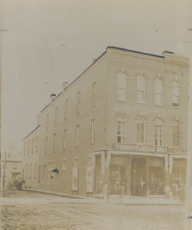 Three storey store front with closed awnings.