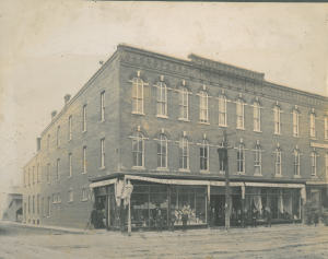 Three storey storefront with employees outside