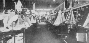 Black and white photograph of fabric on tables.