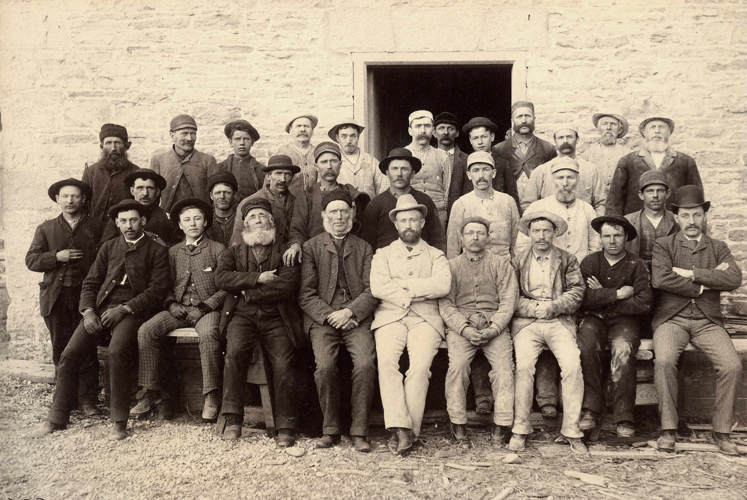 Male employees sitting in front of the doorway.