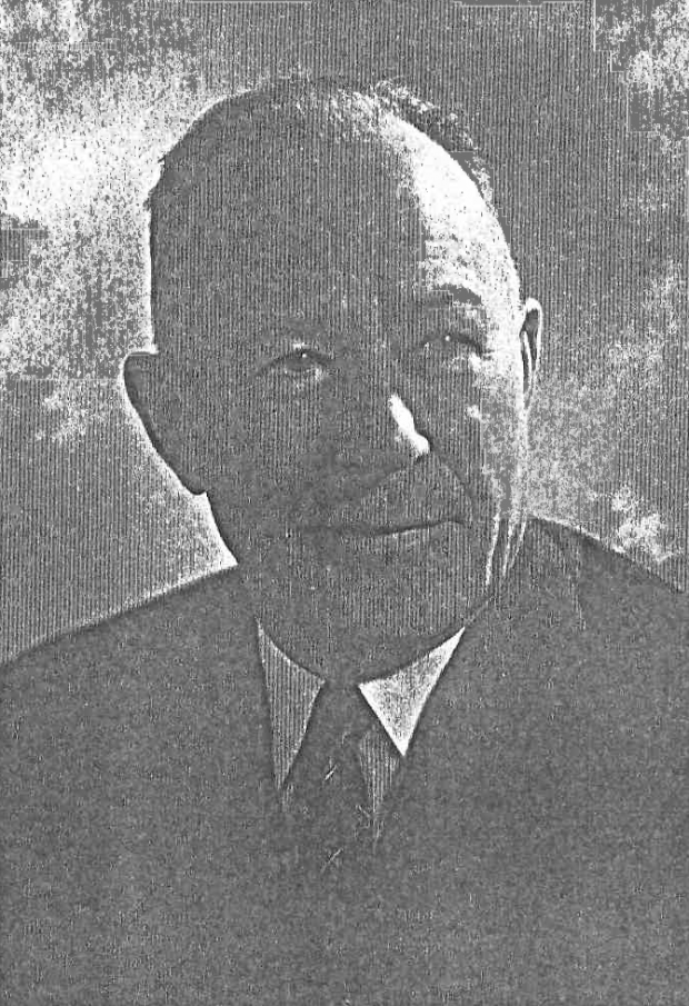 Black and white photograph of an elderly man wearing a black suit and is balding.