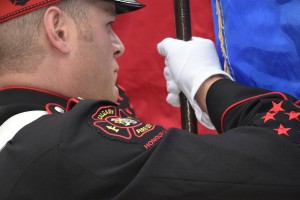 Close up of Honour Guard flag bearer in dress uniform, focus on right shoulder patch.