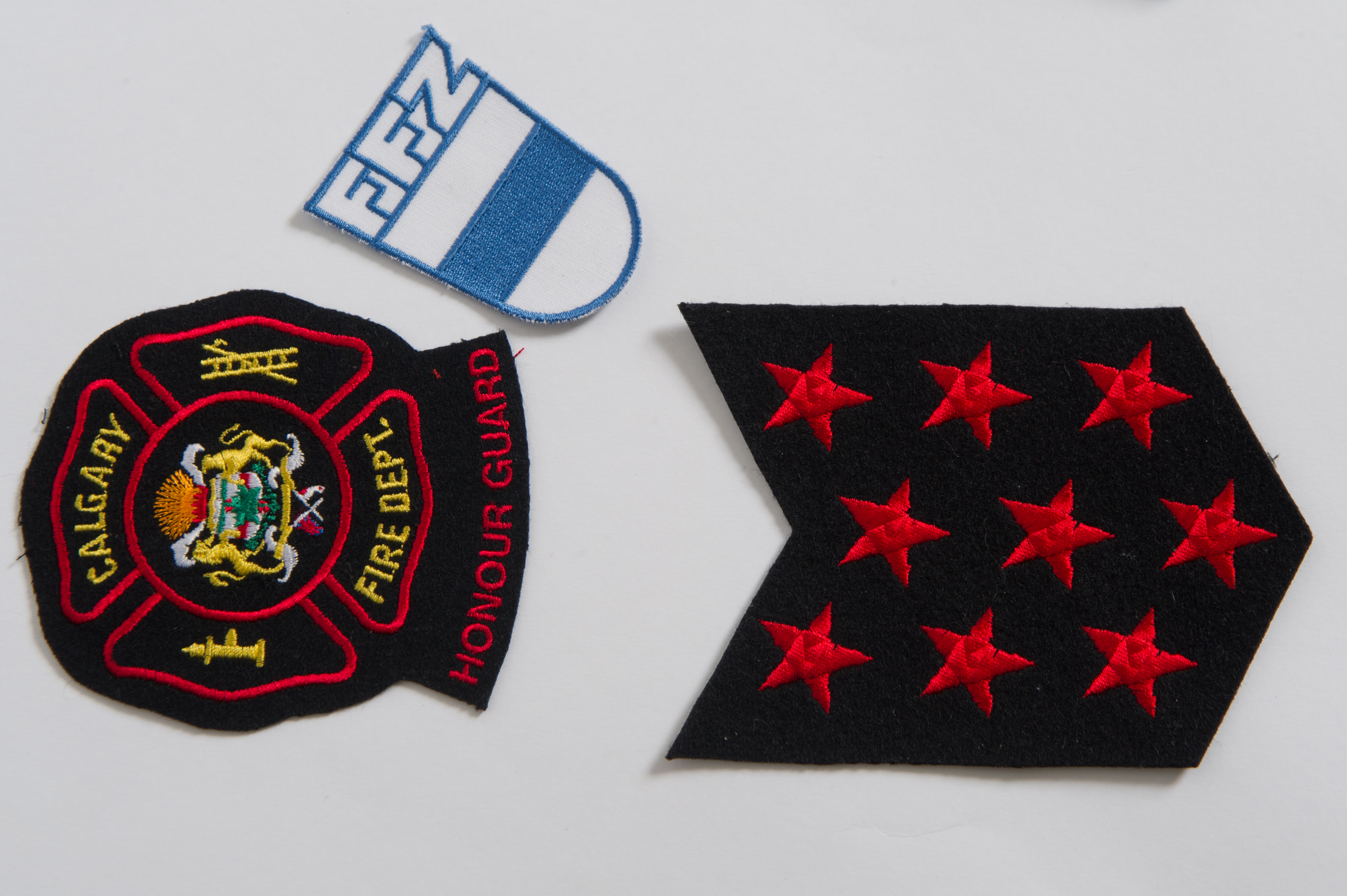 Three patches are shown- the CFD crest with city of Calgary logo, the 9 red stars, and a blue and white patch with FFZ, from Switzerland.