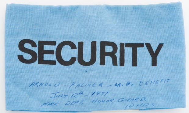 Blue patch labelled Security in black block letters, with handwritten notes in blue ink about the Arnold Palmer benefit event