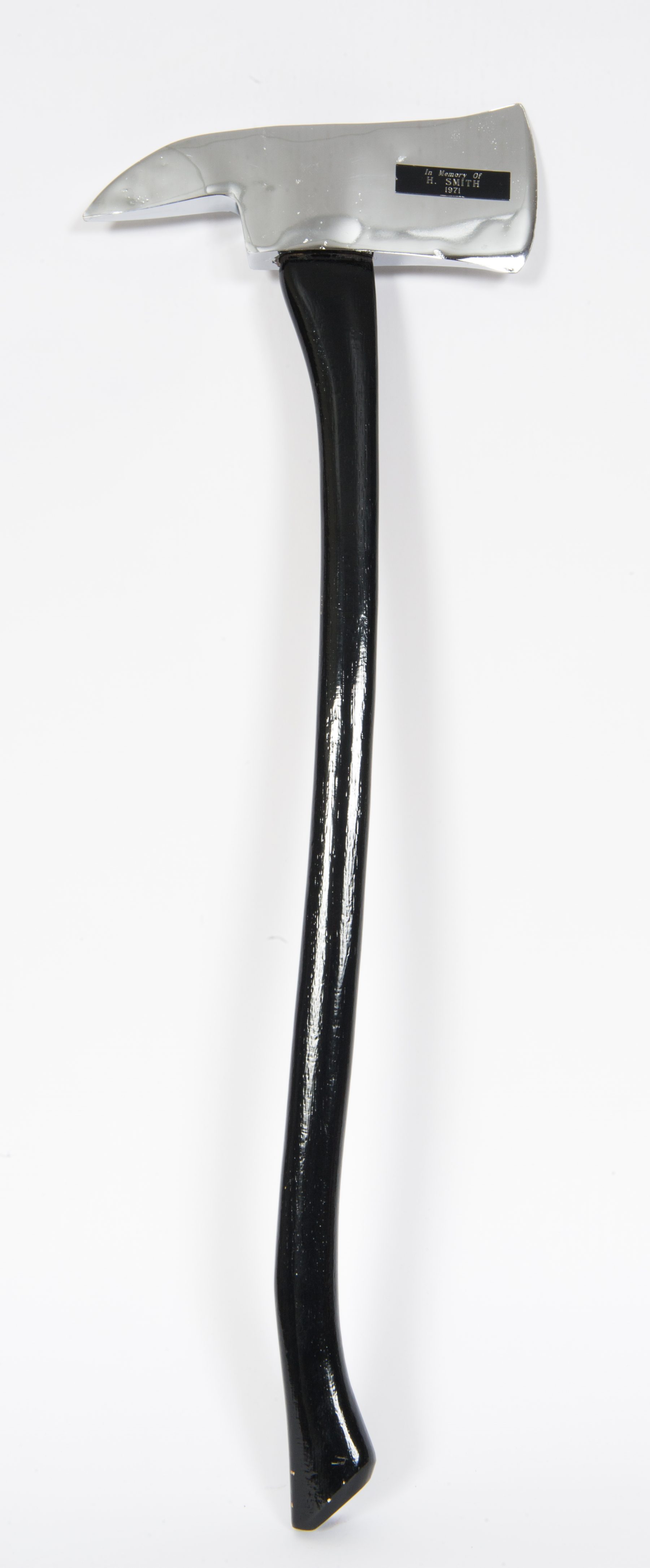 Ceremonial axe with black handle and silver head, showing the name of Harold Smith.