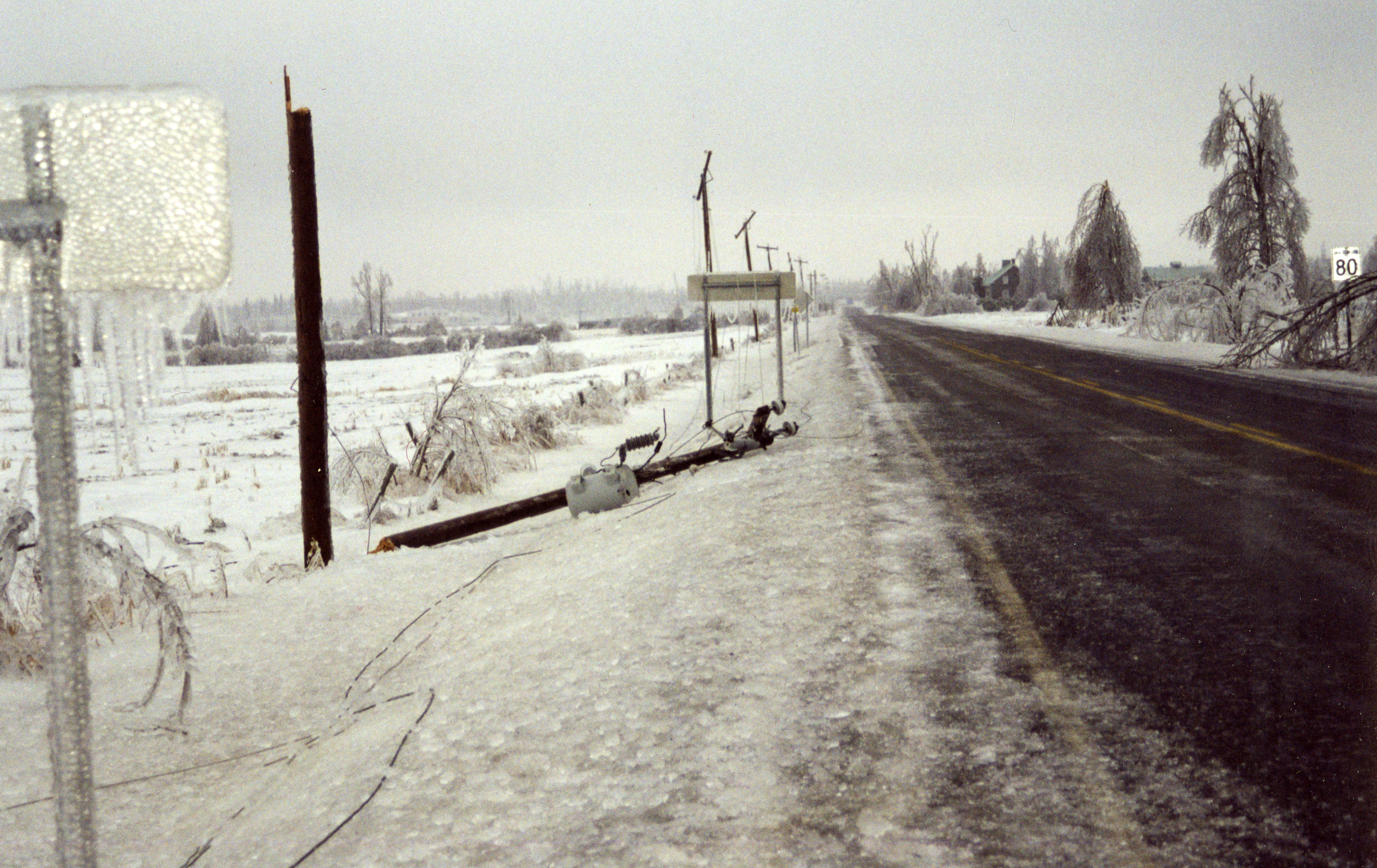 The electrical wires covered in ice dragged the electrical poles down.