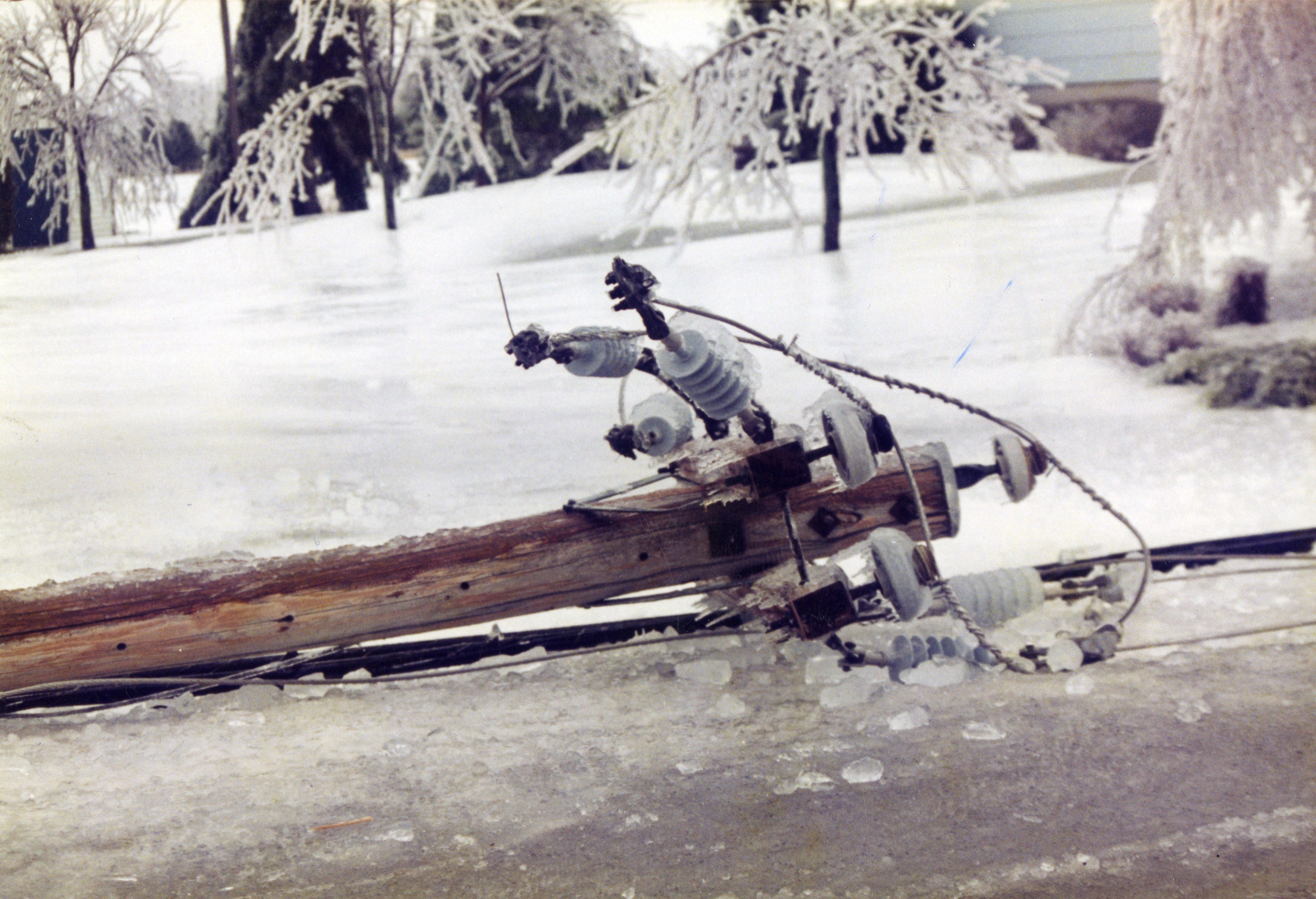 The ice shattering when the electrical pole fell to the ground.