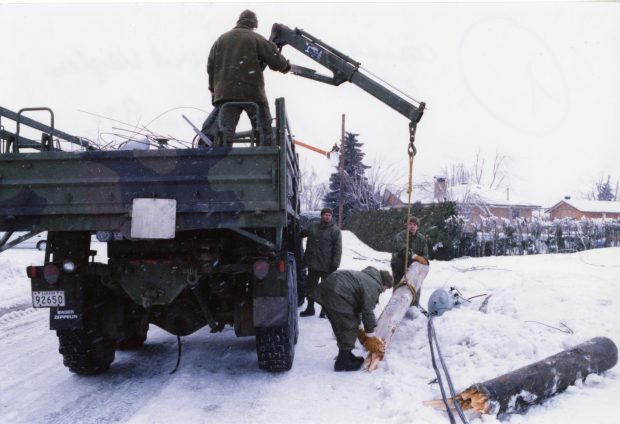 The military had the necessary equipment to clear the poles that had fallen on the road.