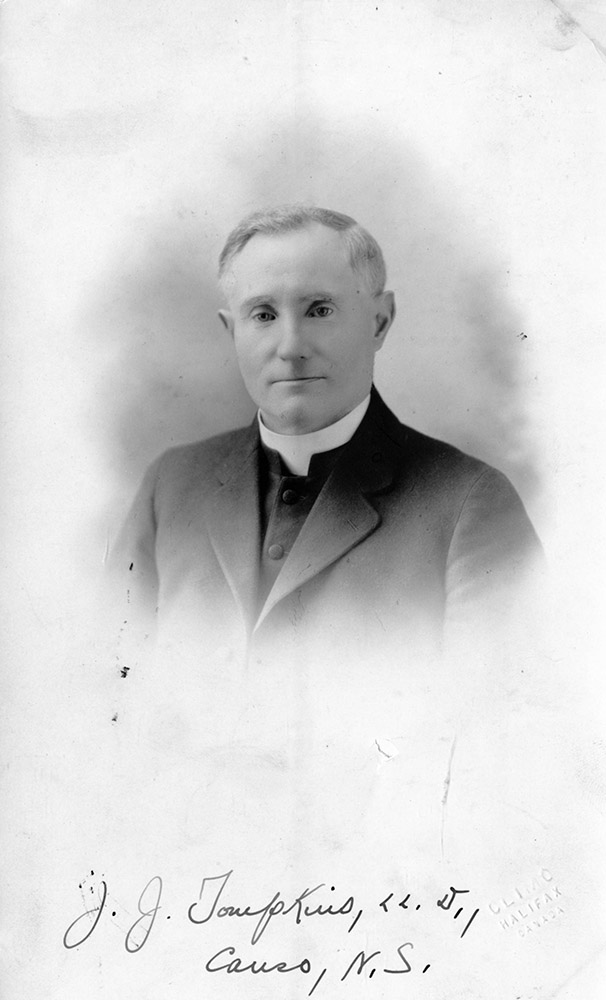 Black and white portrait photograph of Father Tompkins. written at the bottom J.J. Tompkins Caruso, N.S.