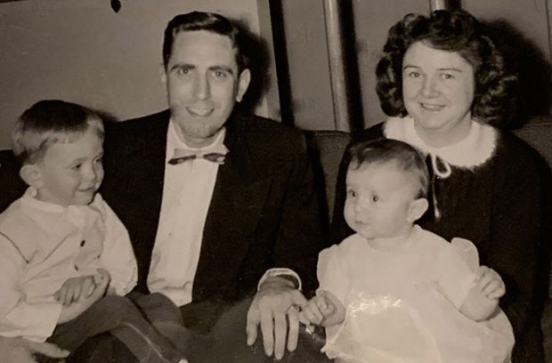 Black and white photograph of a family. two adults and two children