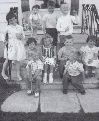 A Black and white photograph of a group of children on stairs