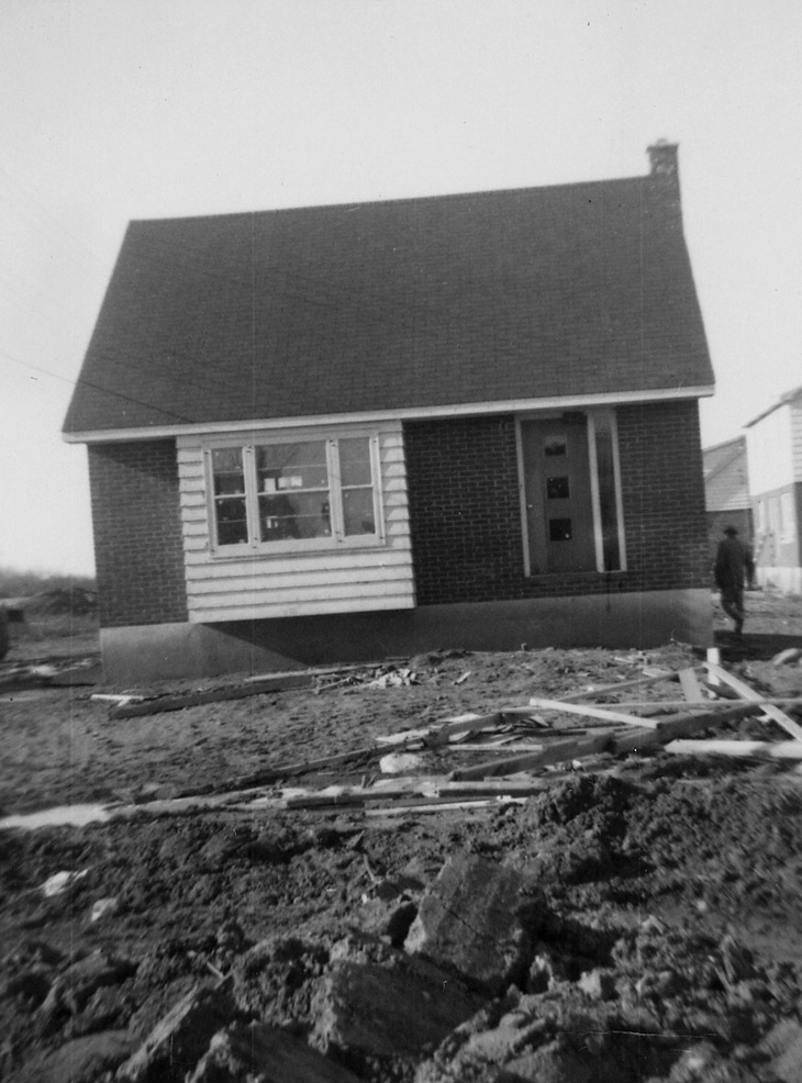 black and white photograph of a house under construction