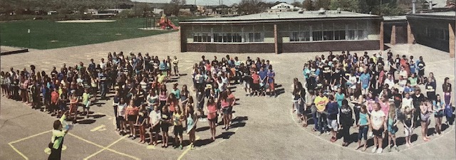 colour photograph of students at Lakeview school. Children are in groups forming the letters "LSC"
