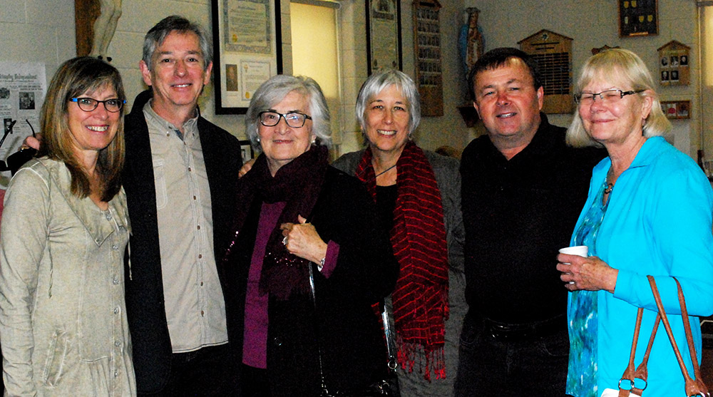 A Colour photograph of a group of people. Two men and four women