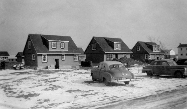 Black and white photograph of a group of houses under construction
