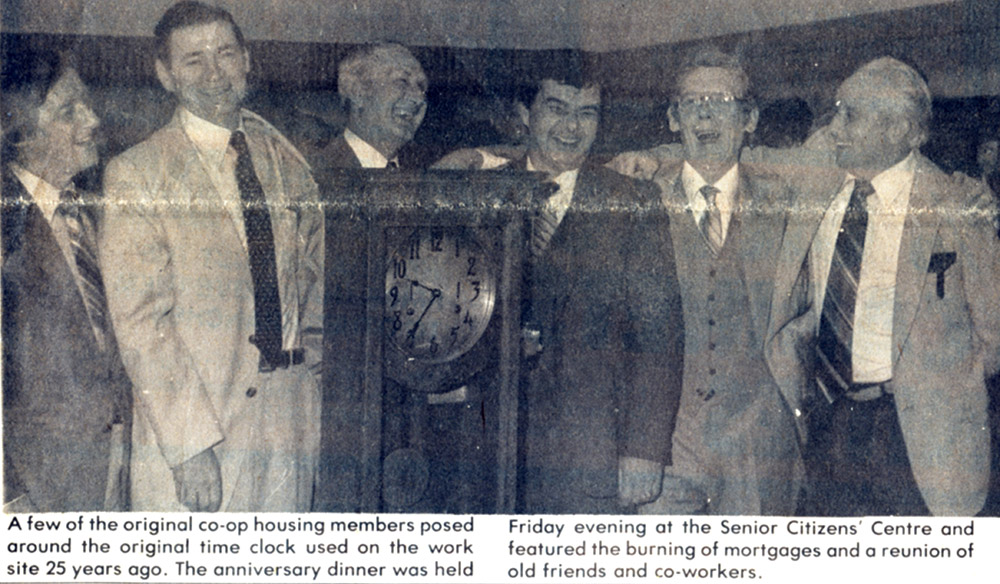 Newspaper article. No title. Photograph of 6 men standing around a time clock