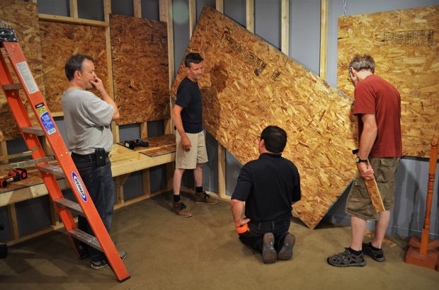 group of people building a museum exhibit