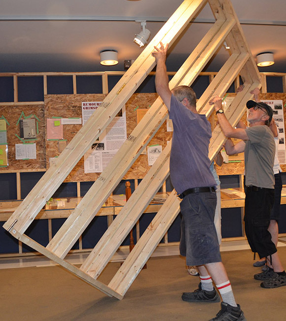Colour picture of two people building an exhibit