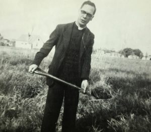 Photograph of a man holding a shovel