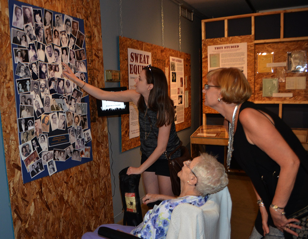 Colour photograph of a family looking at a poster