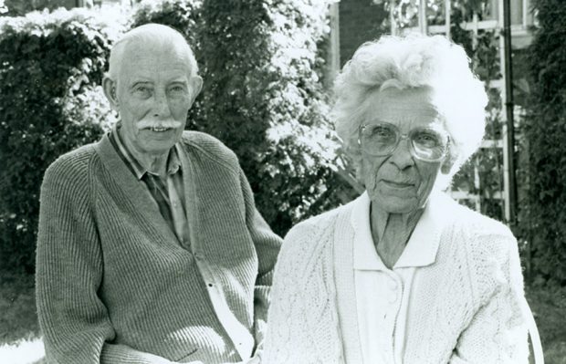 Black and white photograph of a man and a woman in a backyard