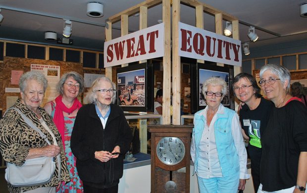 Colour photograph of a group of women at a museum exhibit Sweat Equity